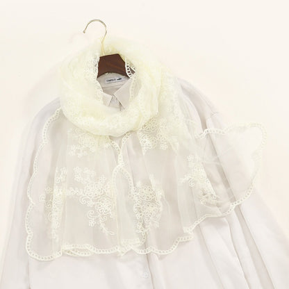 Close-up of embroidered floral and scroll motifs on Scarvii sheer scarf