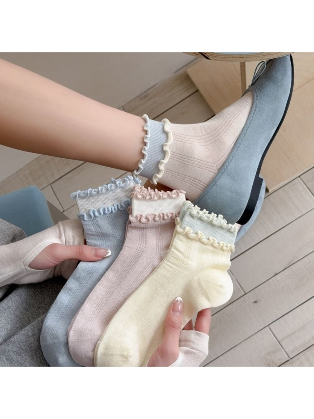 Rufia Sweet Frill Edge Ribbed Socks in beige shown folded with ribbed texture visible