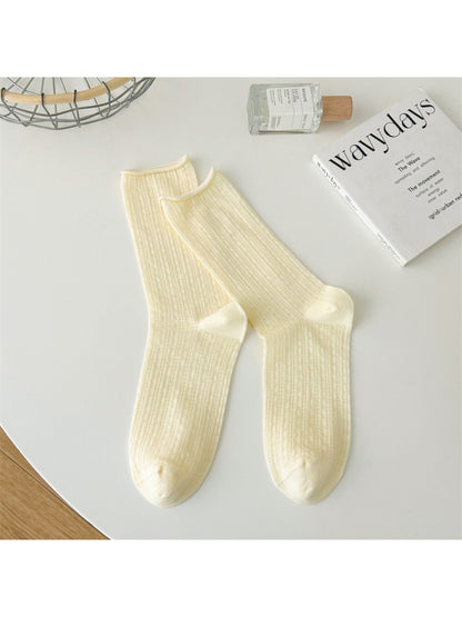 Rufia rolled edge textured crew socks in beige paired with denim jeans