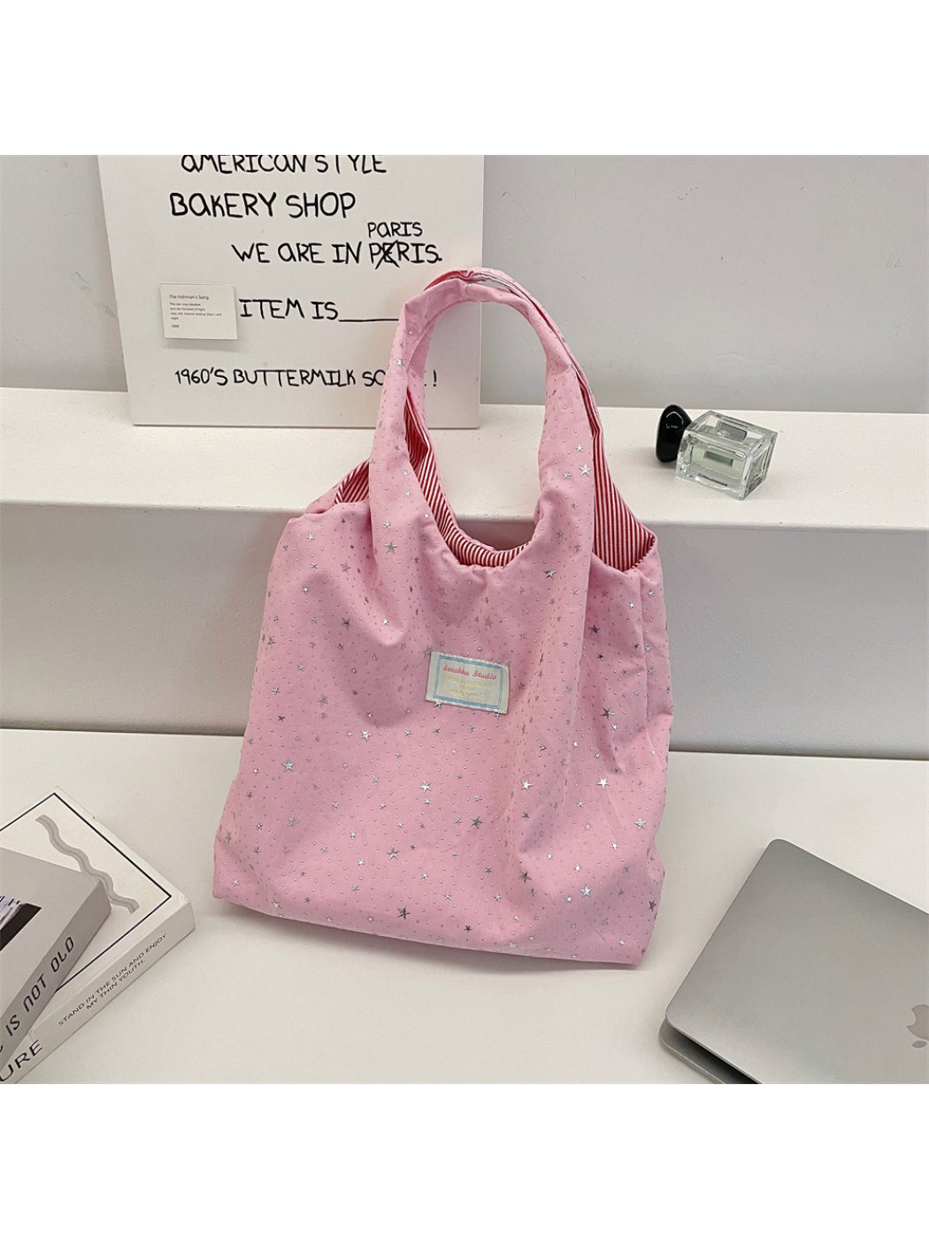 Cosbai star pattern tote bag displayed hanging by handles