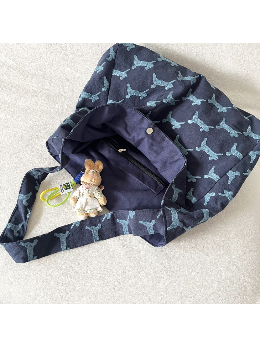 Cosbai oversized hobo bag displayed on wooden surface with rabbit print