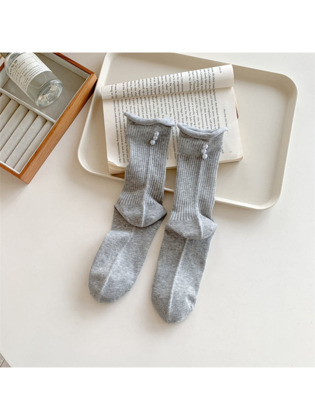 Rufia crew socks folded neatly to show ribbing and bead decoration