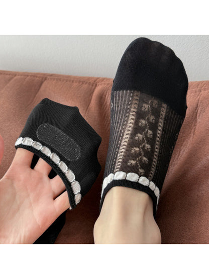 Rufia no show socks worn on feet with light blue jeans