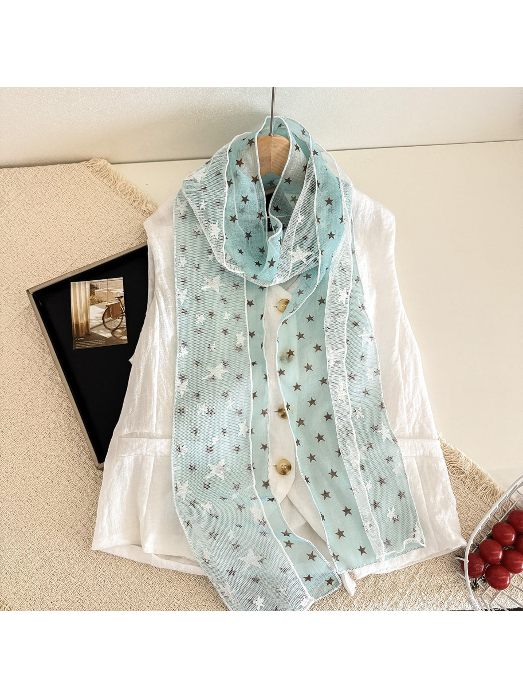 Scarvii sheer scarf with white stars displayed with matching black outfit