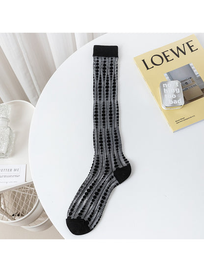 Pair of Rufia lace floral knee high socks displayed flat on white background