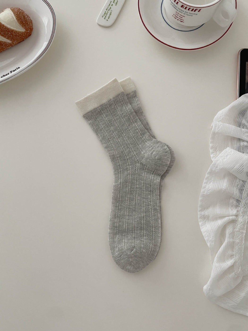 Stack of Rufia soft tone contrast ribbed socks in various neutral colors