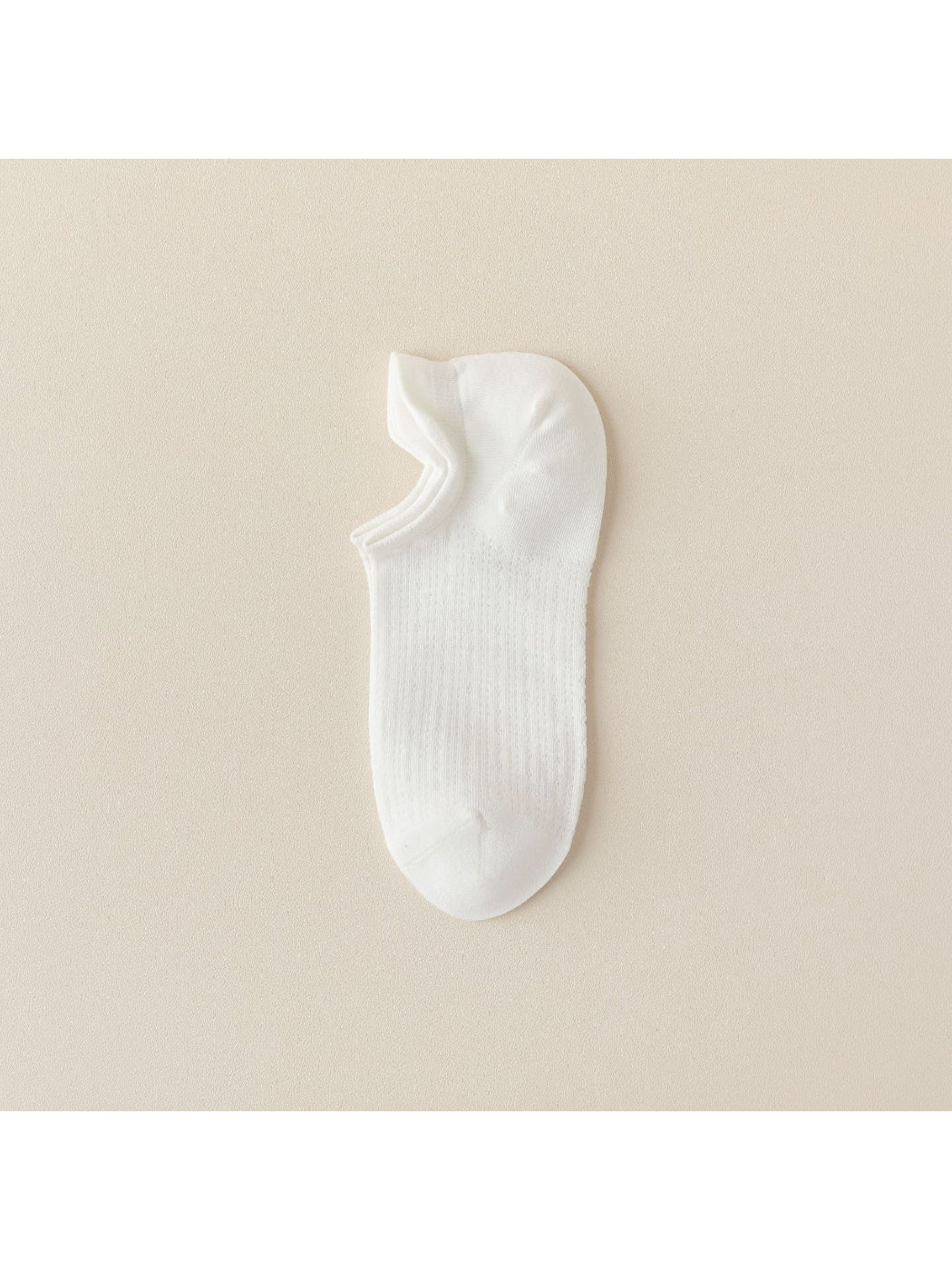 Black liner sock worn on foot, showing low-cut design
