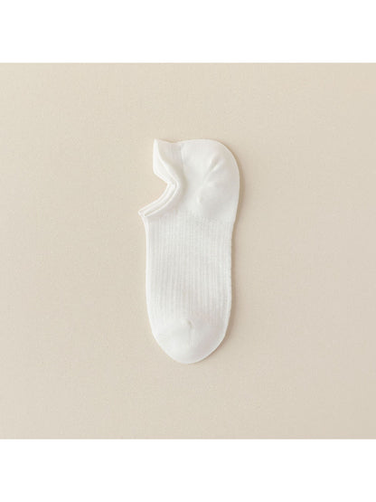 Black liner sock worn on foot, showing low-cut design