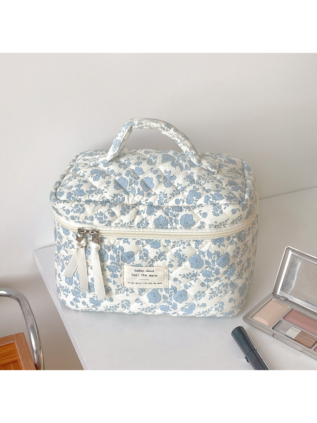 Close-up of Cosbai blue floral quilted vanity bag showing detailed stitching and floral design