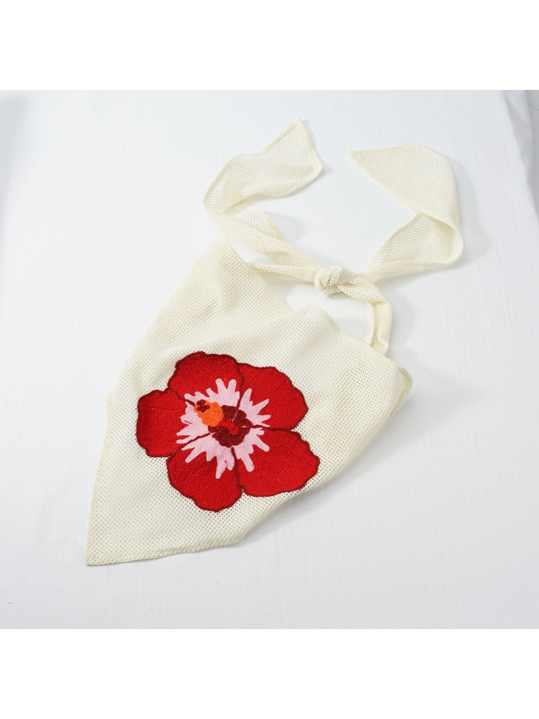 Close-up of colorful floral embroidery on Scarvii bandana scarf fabric
