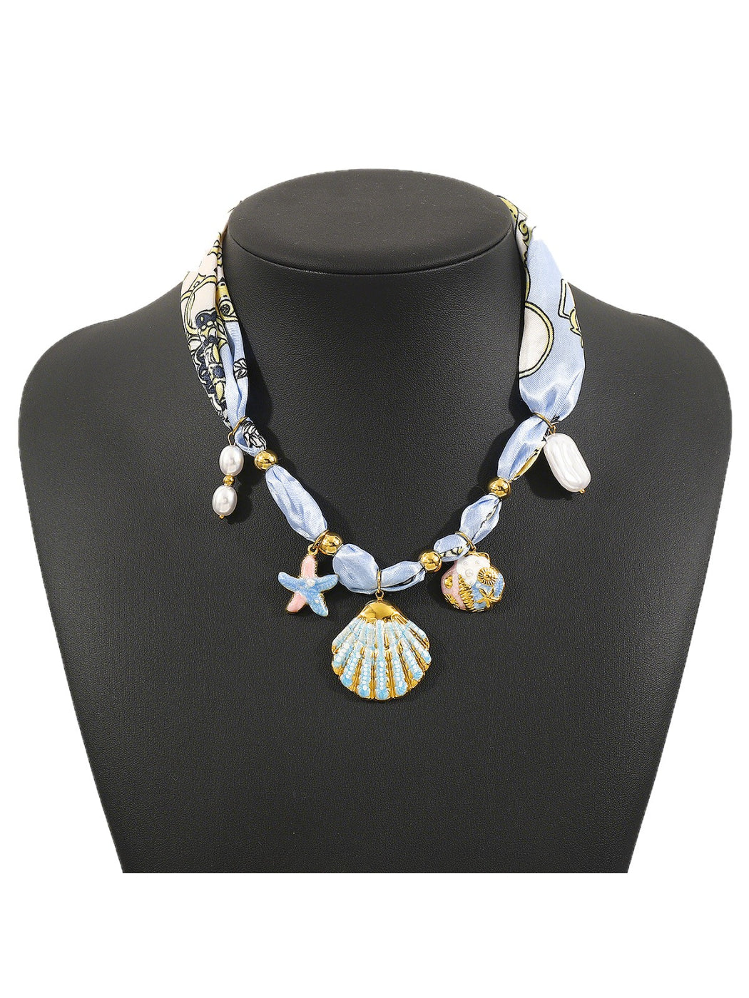 Neckit Botanical Charm fabric necklace with green leaves and flower charms on white fabric