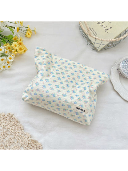 Cosbai cosmetic pouch placed on white surface with floral ribbed design visible