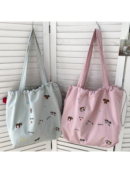Cosbai drawstring shoulder bag showing strap and horse print pattern