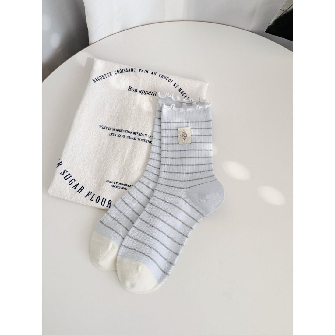 Rufia Lettuce Edge Stripe Crew Socks displayed with packaging