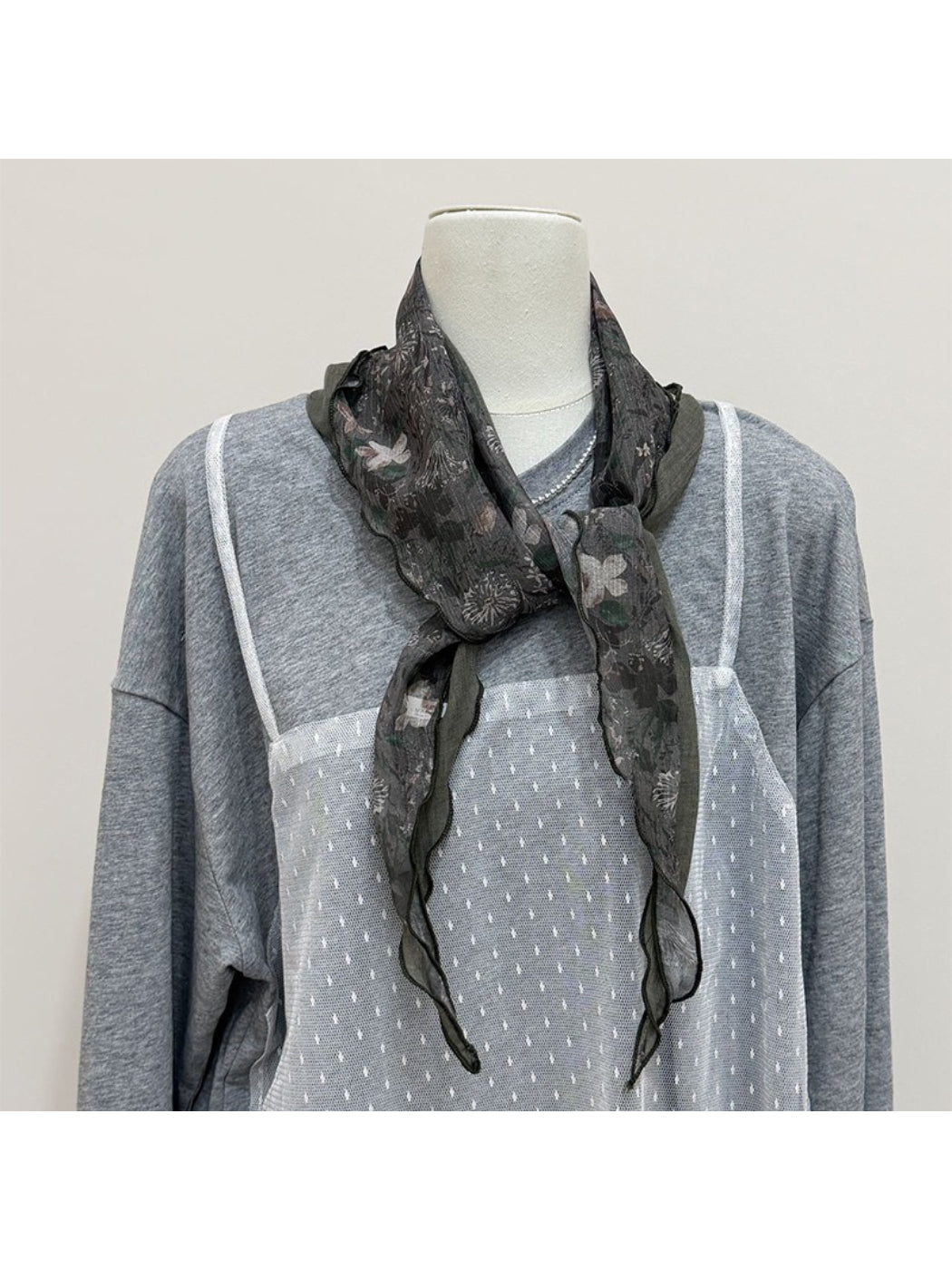 Close-up of scarf fabric texture with botanical print in natural light