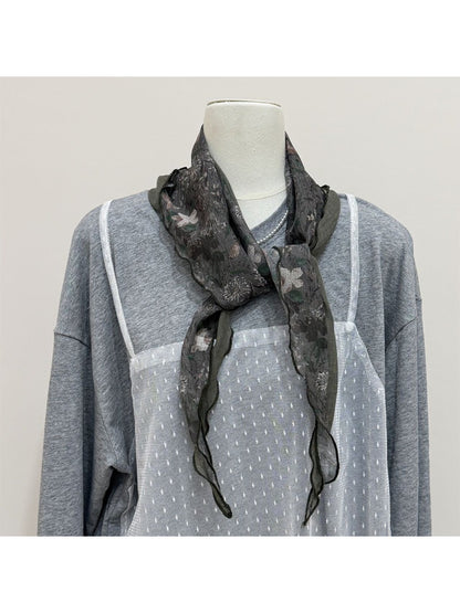 Close-up of scarf fabric texture with botanical print in natural light