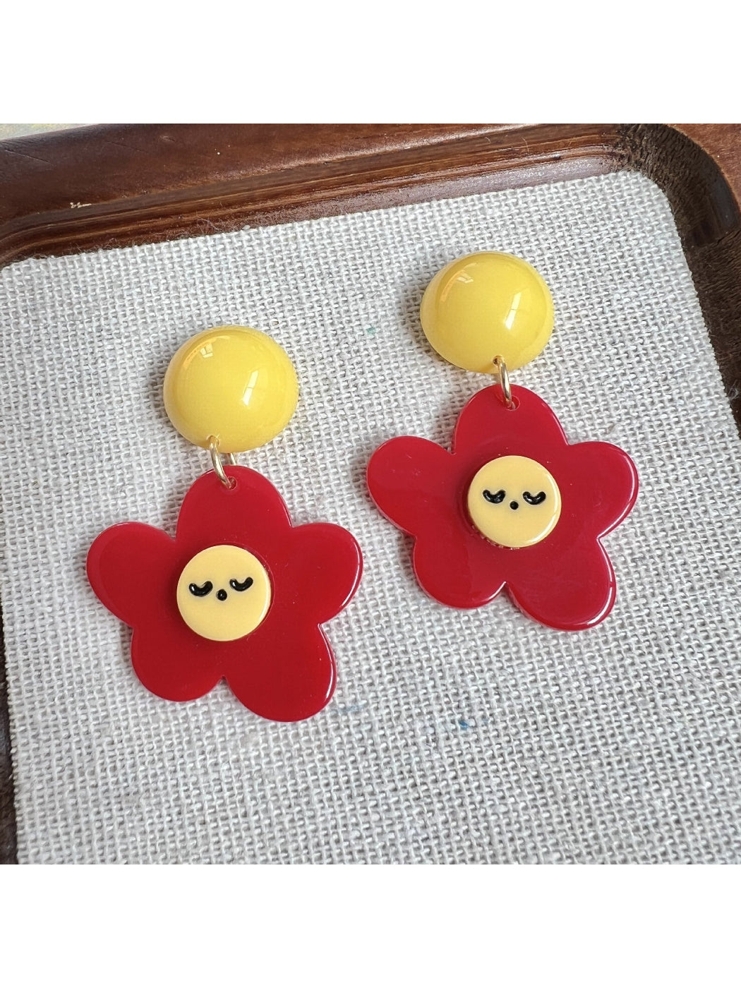 Earwish Smiley Flower Drop Earrings worn on ear showcasing size and style