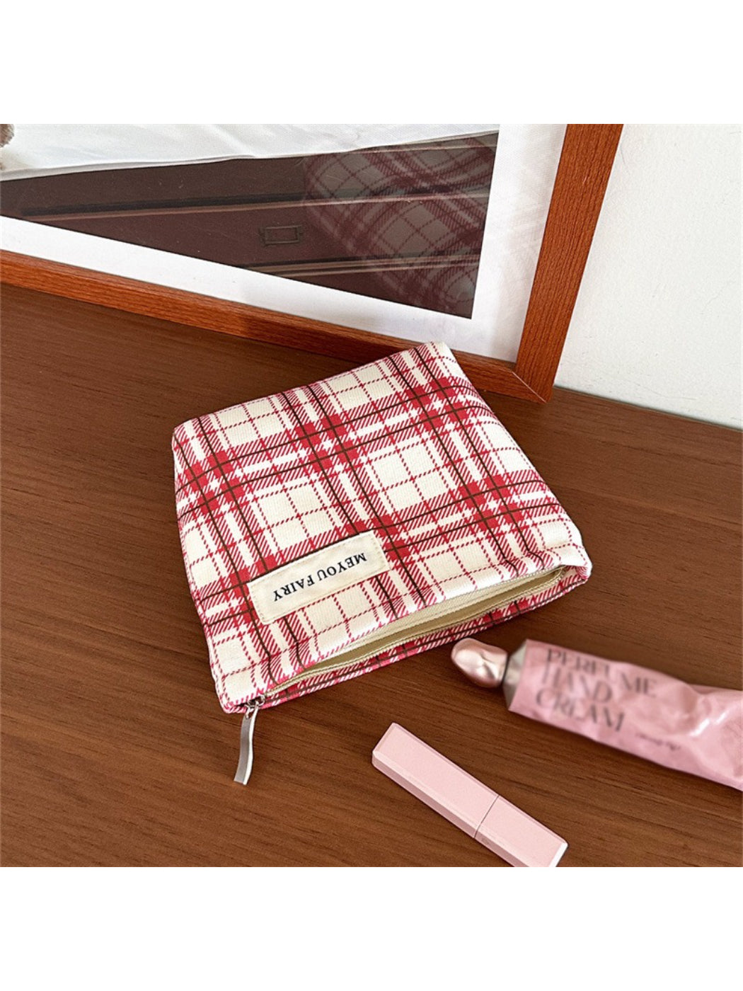 Side view of Cosbai red plaid cosmetic bag highlighting its shape and plaid design