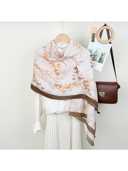 Close-up of Scarvii wrap scarf fabric highlighting detailed leaf print design