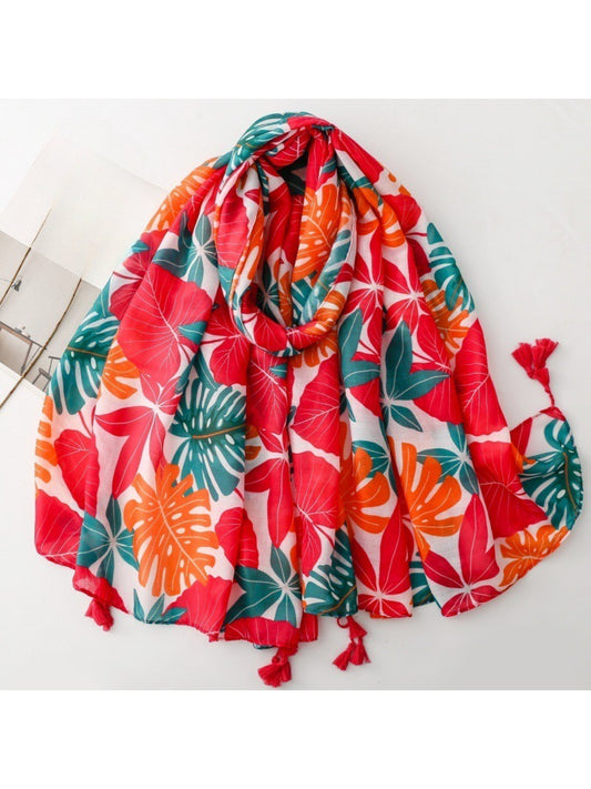 Scarvii bold botanical print scarf folded showing green and orange leaf patterns on white background