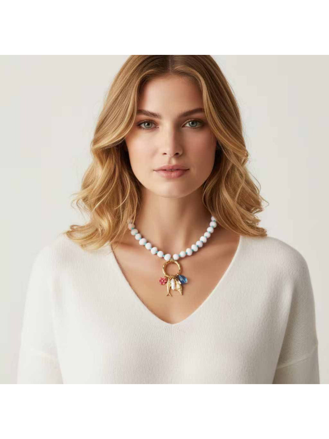 Close-up of Neckit beaded necklace featuring a ring charm detail on a white background