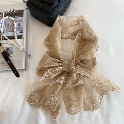 Sheer botanical mesh scarf displayed on a hanger against a white background