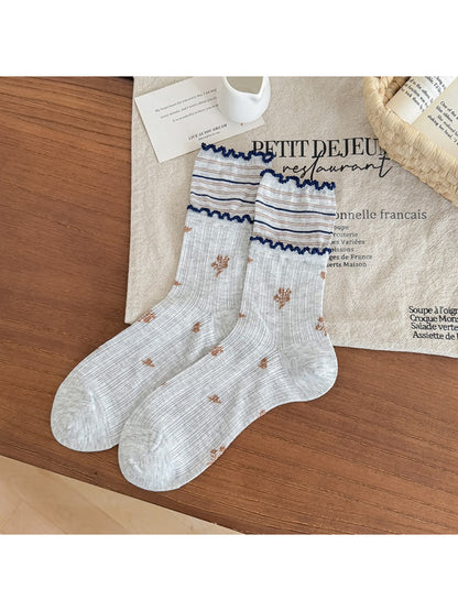 Rufia floral crew socks worn on feet showing fit and frill edges