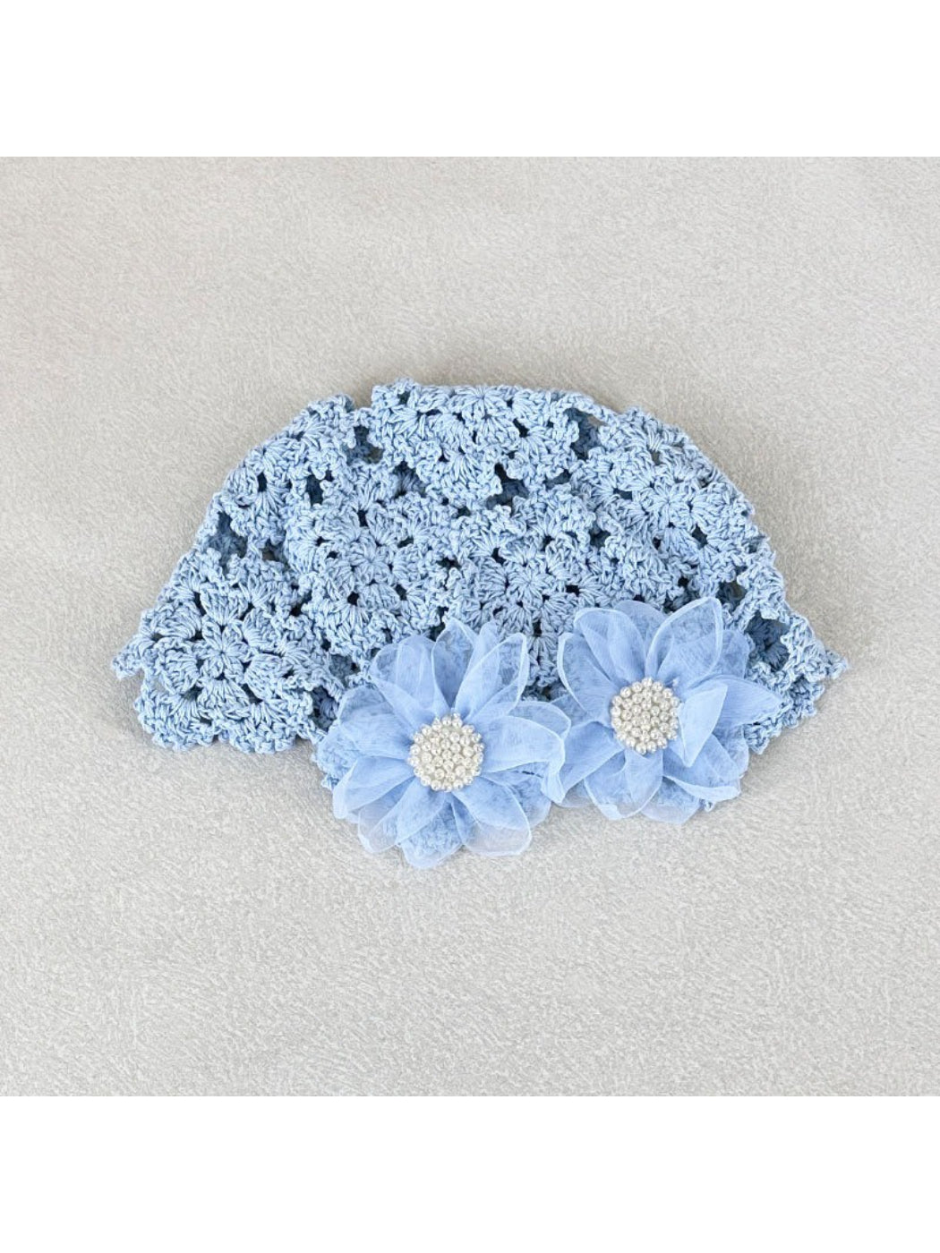 Top view of Haila openwork hat highlighting floral design and airy knit pattern