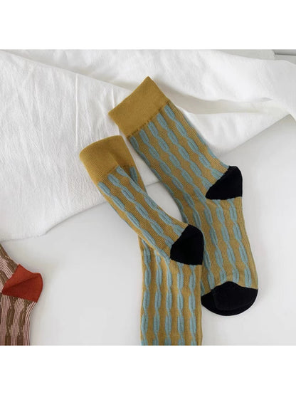 Top view of Rufia bold graphic knit crew socks showing ribbed cuff