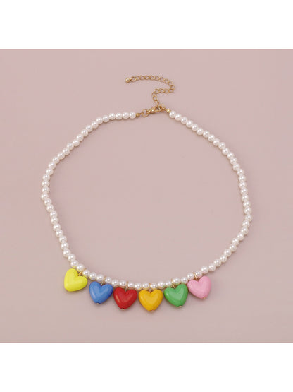 Neckit necklace with multicoloured heart charm worn on a model's neck