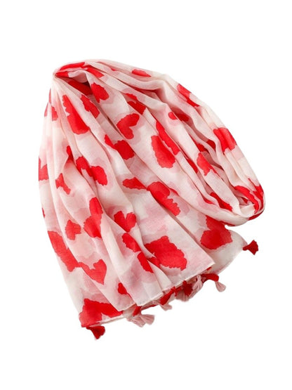 Scarvii Heart Print Tassel Scarf draped over chair highlighting texture and pattern