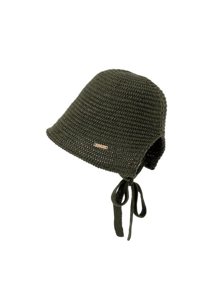 Haila crochet hat displayed on a wooden surface with natural lighting