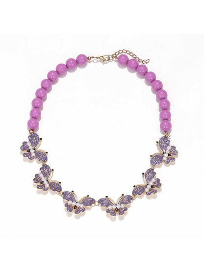 Neckit Butterfly Necklace with beaded detail laid flat with a blurred background