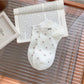 Model wearing Rufia Everyday Polka Dot Socks paired with casual shoes
