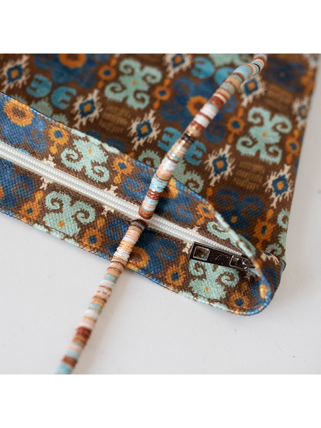 Side view of Cosbai Boho Ethnic Tassel Tote showing tassel detail