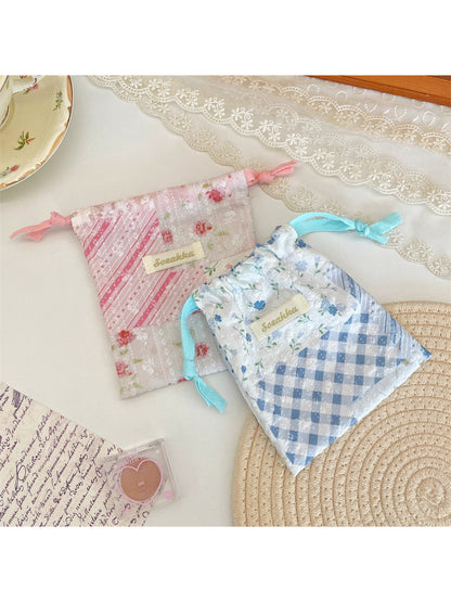 Close-up of floral patchwork design and drawstring closure on Cosbai pouch