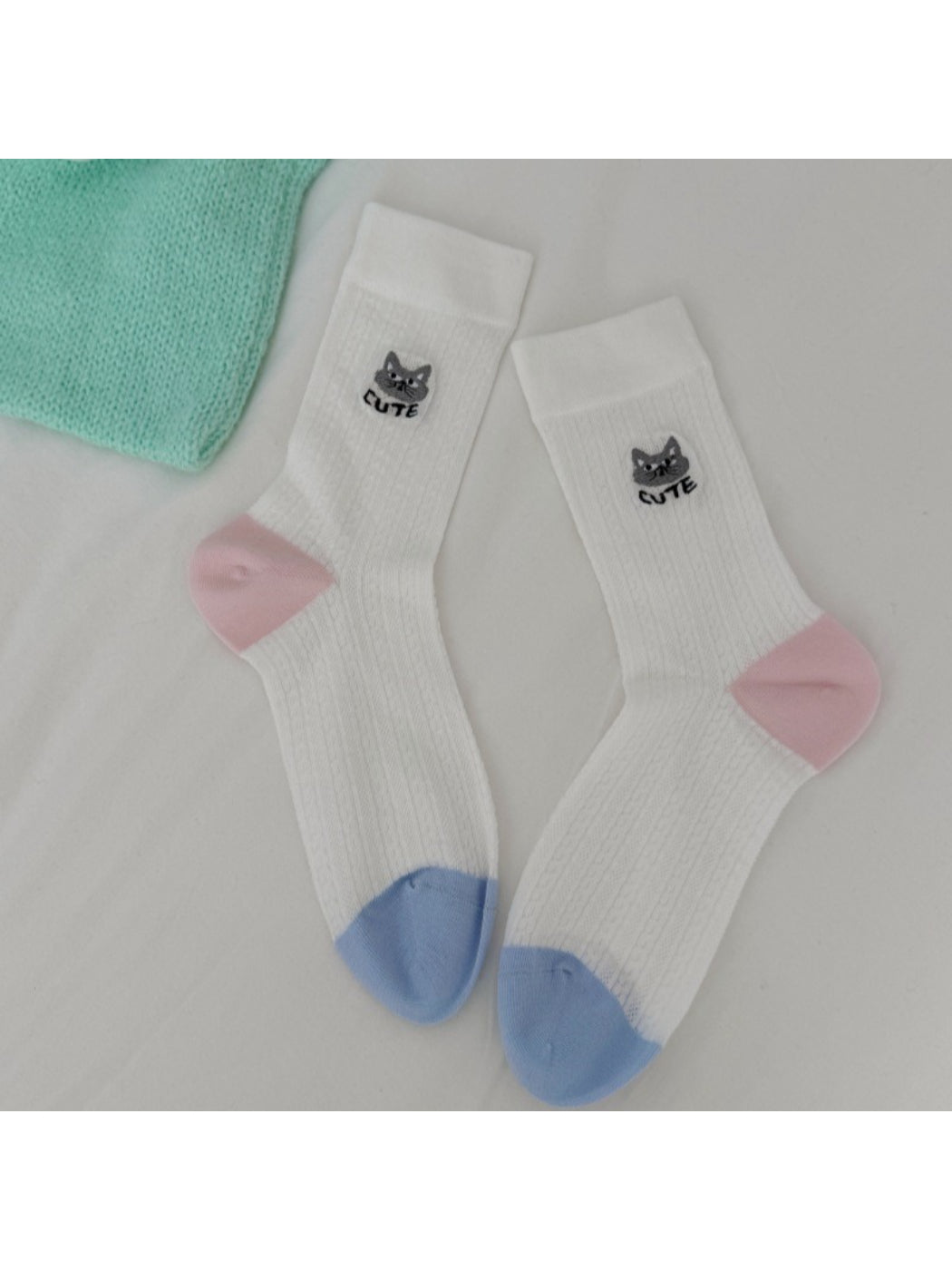 Multiple pairs of Rufia cat knit crew socks in various pastel shades
