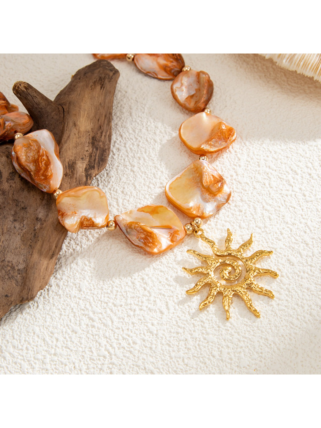 Neckit Boho Sun Charm Necklace styled with layered bracelets and rings