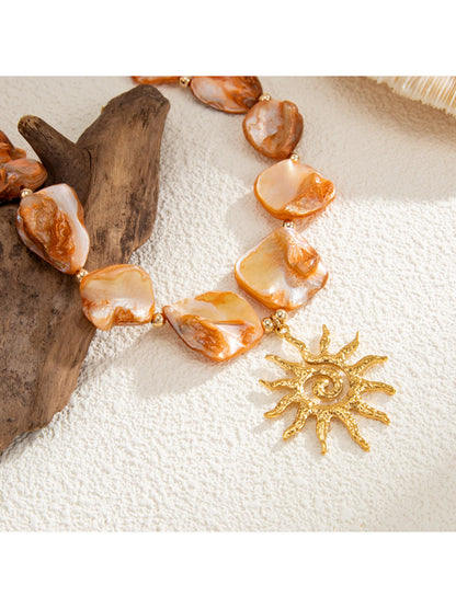 Neckit Boho Sun Charm Necklace styled with layered bracelets and rings
