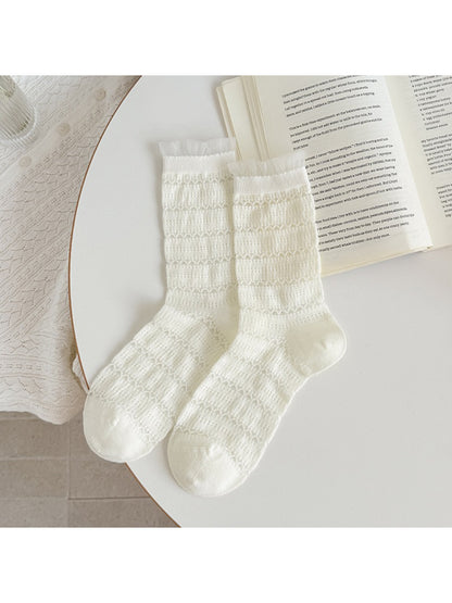 Multiple color options of Rufia ruffle socks arranged in a fan shape