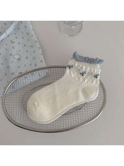 Model wearing Rufia soft floral ribbed crew socks with casual shoes