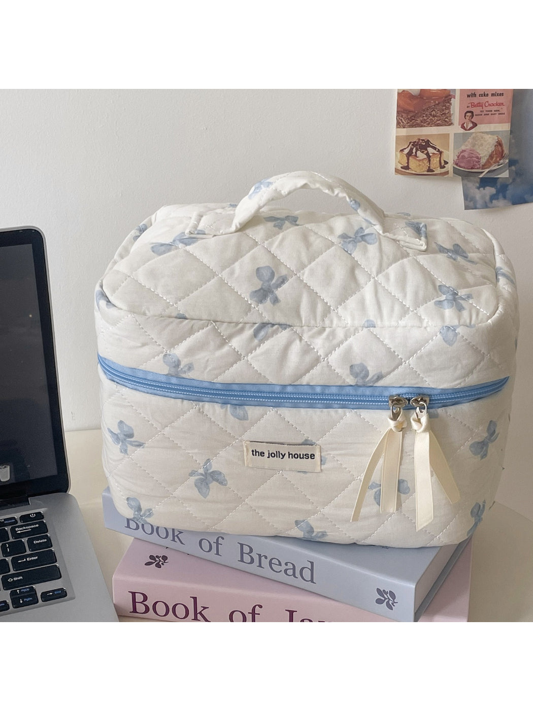 Open view of Cosbai Quilted Bow Cosmetic Case showing interior compartments and zipper