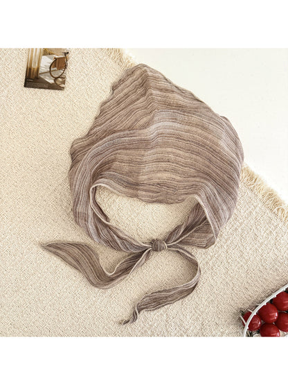 Model styling Scarvii triangle scarf tied loosely around the neck with casual outfit
