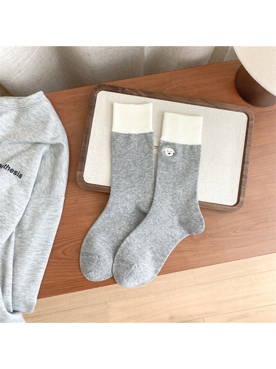 Stack of Rufia soft crew socks in various colors featuring different animal embroidery