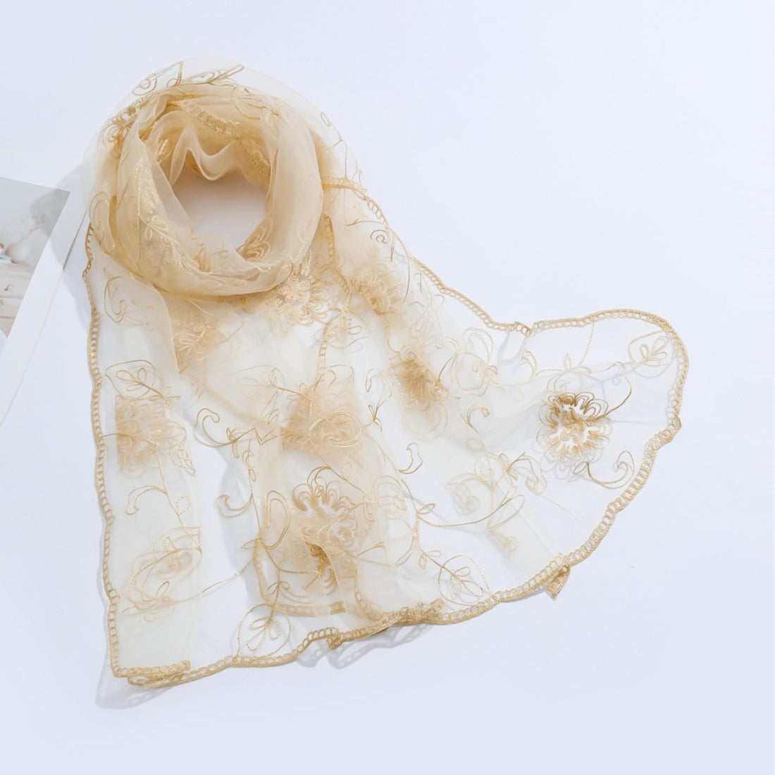 Close-up of scarf edges highlighting fine mesh and floral details