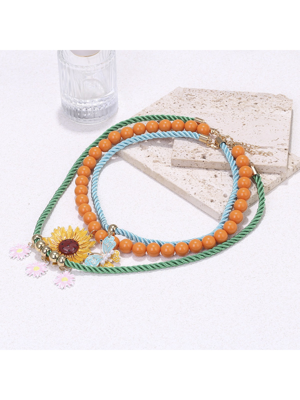 Close-up of Neckit Sunflower Charm Rope Necklace showing sunflower charm and floral details
