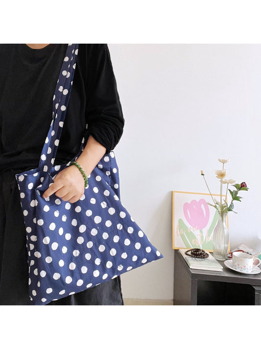 Close-up of navy polka dot fabric and handle stitching on Cosbai tote bag