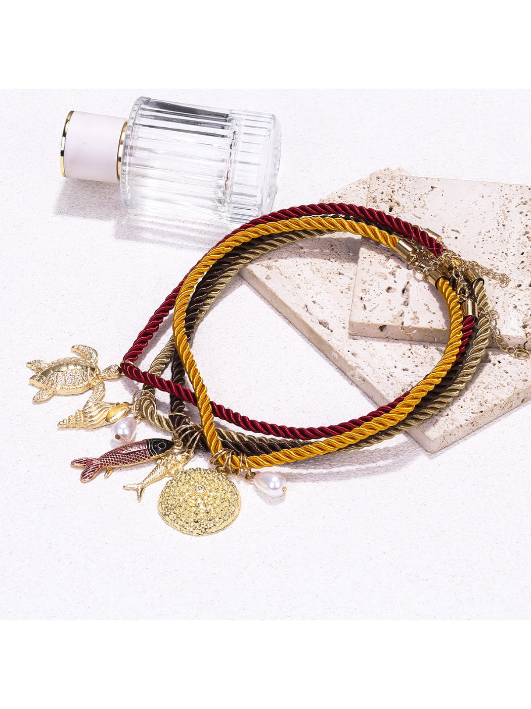 Neckit multi strand rope necklace displayed flat showing ocean charms