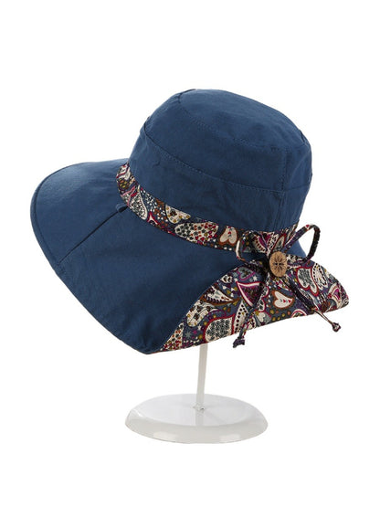 Model wearing the Haila paisley ribbon sun hat outdoors in natural light
