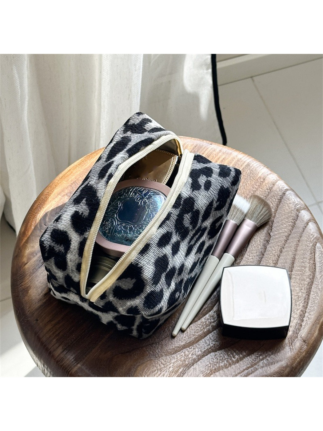 Cosbai chic leopard print travel makeup bag placed on a vanity table